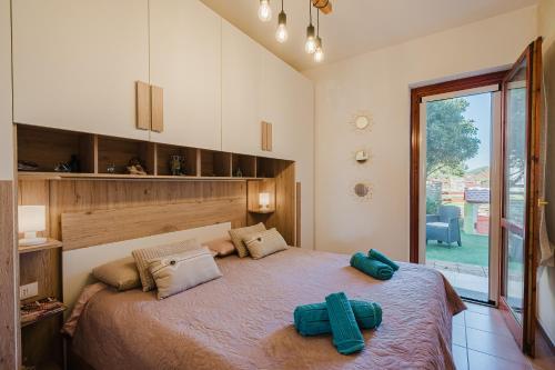 a bedroom with a large bed with two crosses on it at villetta giulia fronte mare in Stintino