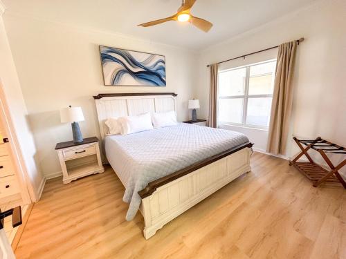 a bedroom with a bed with a ceiling fan and a window at Destin Harbor Escape in Destin
