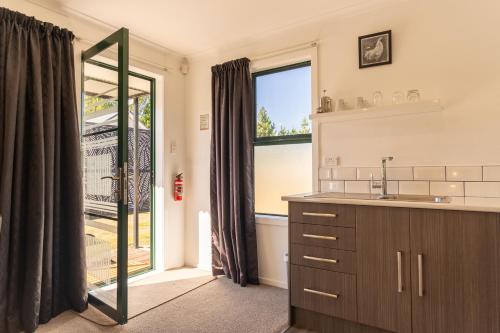 a bathroom with a sink and a large window at The Dales in Twizel