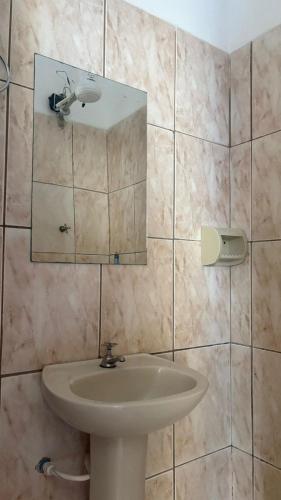 a bathroom with a sink and a mirror at HOTELSÃORAFAEl in Água Boa
