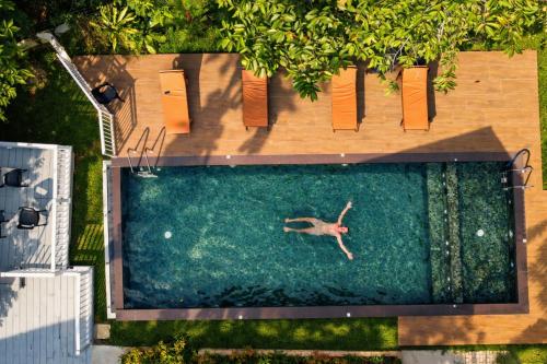 an overhead view of a person swimming in a pool at Django Villa Weligama in Weligama