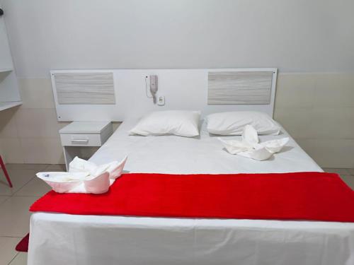 a large white bed with two white pillows on it at Hotel Senna in Arapiraca