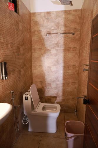 a bathroom with a toilet and a sink at Rio Casa Homestay in Cochin