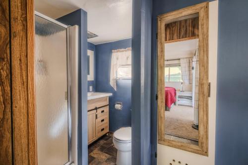 a bathroom with a toilet and a mirror at Gonzalez Cabin in Running Springs