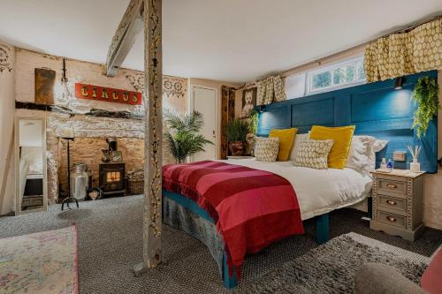 a bedroom with a large bed and a fireplace at One Drake Road Hotel in Tavistock