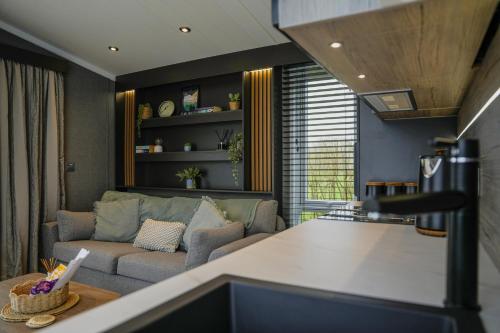 a living room with a couch and a living room with at Dawns Rest in Rhayader