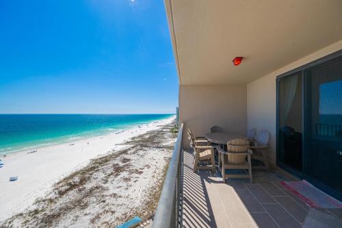 a balcony with a table and a view of the beach at Phoenix X 1110 in Orange Beach