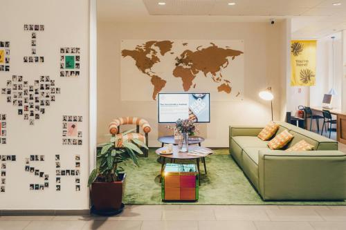 a living room with a couch and a map on the wall at The Social Hub Paris La Défense in Puteaux