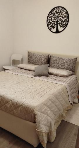 a bedroom with a bed with a tree on the wall at S1 Home Sila in Camigliatello Silano