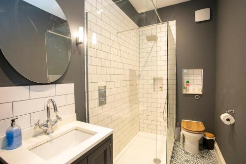 a bathroom with a shower and a sink and a toilet at Seaview in Worthing