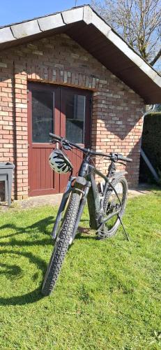 a bike parked in the grass in front of a building at Bulle d'eau in Gouvy