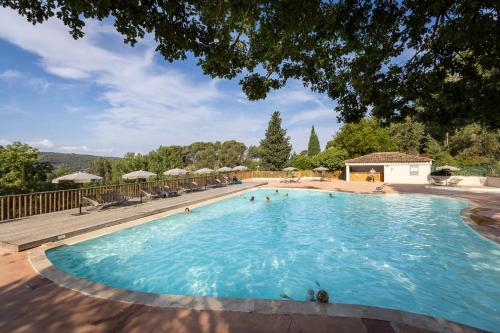 a large swimming pool with people in the water at Citykamp d'Aix-en-Provence in Aix-en-Provence