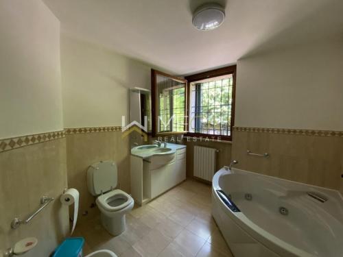 a bathroom with a tub and a toilet and a sink at Apartment 4 in Salò