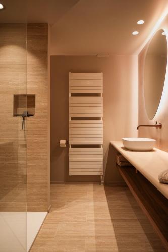a bathroom with a sink and a shower at Tarida Durbuy in Durbuy