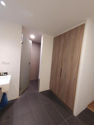 a bathroom with a sliding door and a sink at Sofea Roomstay Hotel in Kota Bharu