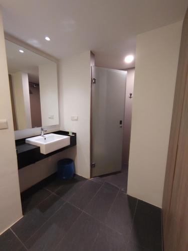 a bathroom with a sink and a mirror at Sofea Roomstay Hotel in Kota Bharu