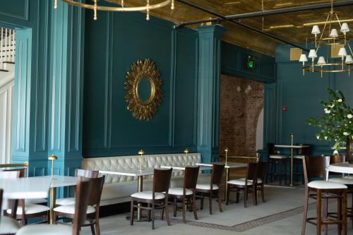 a dining room with blue walls and tables and chairs at The St Nicholas Hotel in Albany