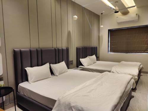 a room with two beds in a room at Exotica Stays in Alibaug