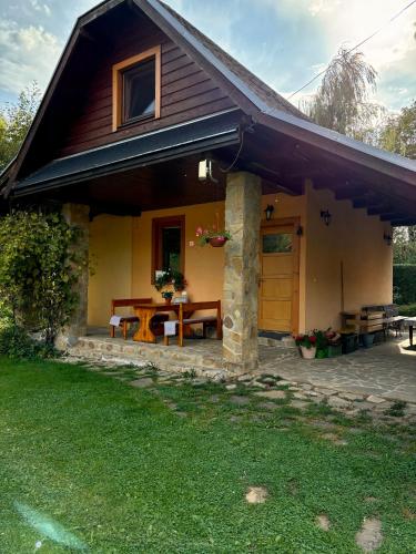 a house with a picnic table in front of it at Country House Liptov in Svätý Kríž