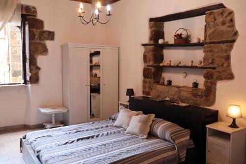 a bedroom with a bed with a mirror and a shelf at Casa Margherita in Bolsena