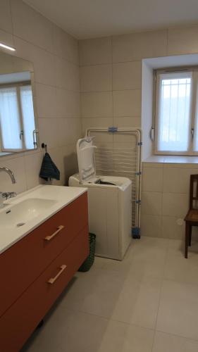 a bathroom with a sink and a toilet in it at Entre pierre & vigne in Arrentières