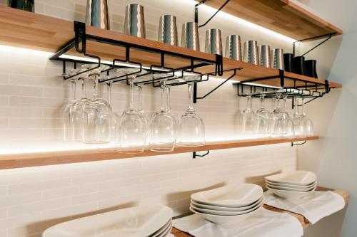 a bathroom with glass bottles and toilets on a shelf at ステラガーデン in Kami-furano