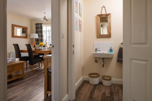 a bathroom with a sink and a desk with a table at Sandy Toes, The Bay, Filey in Filey