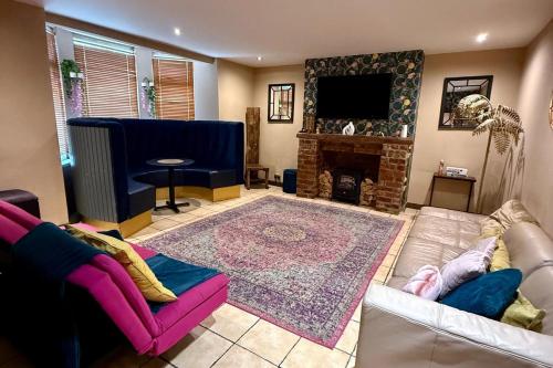 a living room with a couch and a fireplace at 1 Bed Flat - Sleeps 5 - Pet friendly - Parking in South Shields