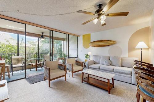 a living room with a couch and a table at Kalanikai #112 in Kailua-Kona