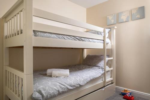 a white bunk bed in a small room at Sandy Toes, The Bay, Filey in Filey