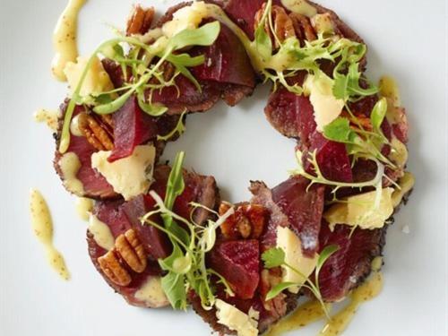 a doughnut with bacon and greens on a white plate at White Hart Cafe Bar & Bistro in Ironbridge