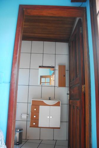 a small bathroom with a sink and a mirror at Samblumba Hostel Trindade in Trindade