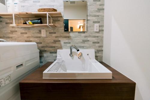 a kitchen counter with a sink in a kitchen at ララリカ in Kami-furano