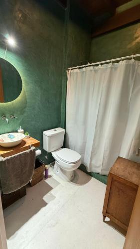a bathroom with a white toilet and a sink at Florida Private loft, shared garden pool in Florida