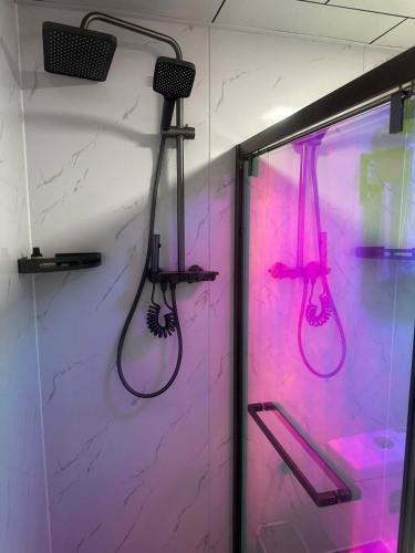 a bathroom with two shower heads on a wall at Mandala Hotel Erdenet in Erdenet