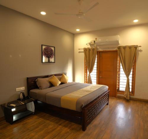 a bedroom with a king sized bed in a room at VILLA De OMR, Private Pool Villa at Old Mahabalipuram Road, Chennai in Kelambākkam