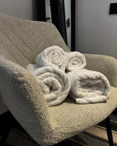 a pile of towels sitting on a chair at Frankies Lodge in Disley