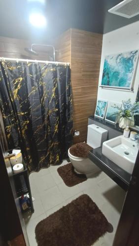 a bathroom with a sink and a toilet and a shower at Manila Bay City Lights in Manila