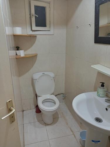 a bathroom with a toilet and a sink at single bed small room in Casablanca
