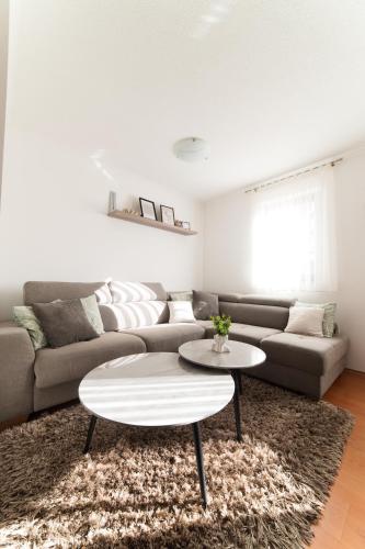 a living room with a couch and a table at Calm Stay Blidinje in Blidinje
