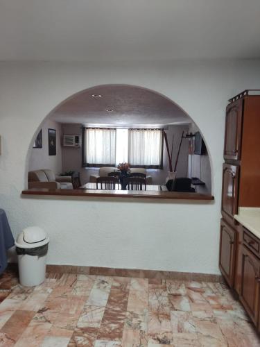 a living room with an arch in the middle of a room at Departamento Deli in Cancún