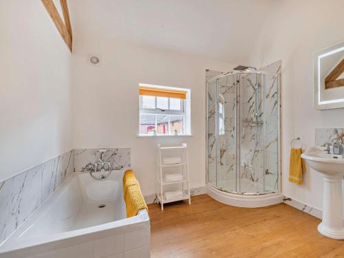 a bathroom with a tub and a shower and a sink at 3 Bed in Ashbourne oc-94309 in Windley