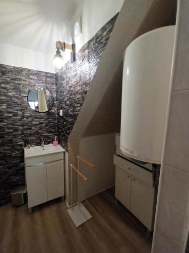 a small bathroom with a sink and a staircase at Casa marreiros in Aljezur