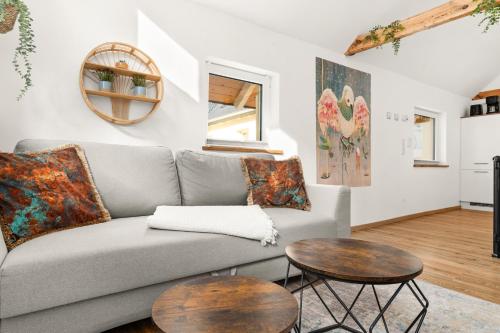 a living room with a couch and two tables at KOLIBRI - Design Maisonette - Nintendo Switch, Streaming, Bikestore, E-Wallbox in Marburg an der Lahn