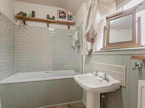 a bathroom with a sink and a bath tub at 2 Bed in Buxton oc-95993 in Hartington