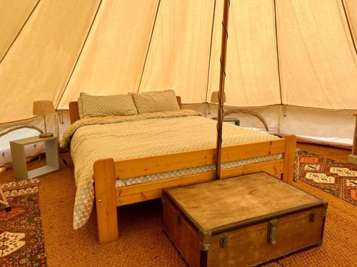 a bedroom with a bed in a tent at Camping équipé : Vallon de Laborie in Astaillac