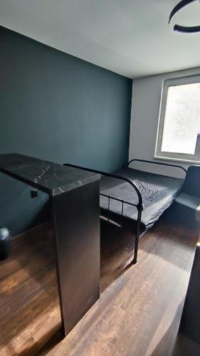 a small room with a bed and a window at Centrum apartman s parkovaním in Trenčín