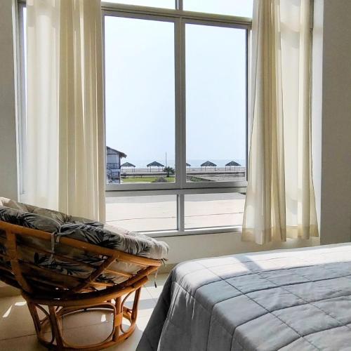 a bedroom with a bed and a large window at Casa Chincha in San Pablo