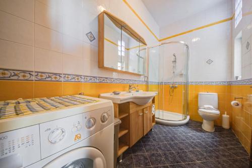 a bathroom with a washing machine and a sink at Davina House - Terrace & Garden - Sea Views in St. Paul's Bay