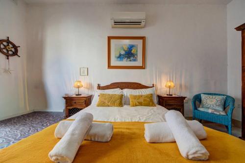 a bedroom with a large bed with two pillows at Davina House - Terrace & Garden - Sea Views in St. Paul's Bay